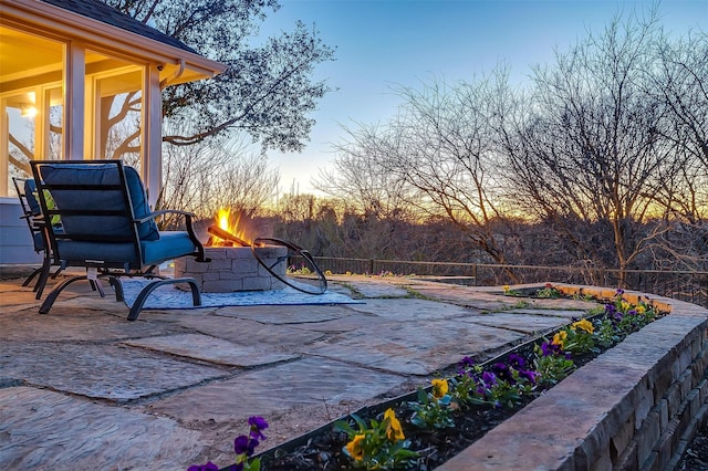 patio terrace at dusk with an outdoor fire pit