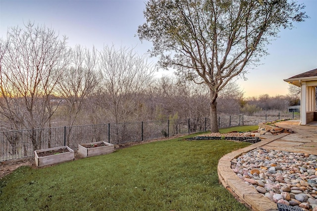 view of yard featuring a vegetable garden and fence