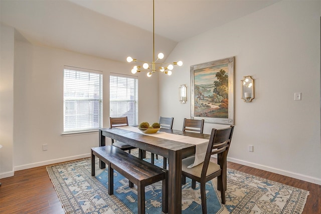 dining room with baseboards, lofted ceiling, and wood finished floors