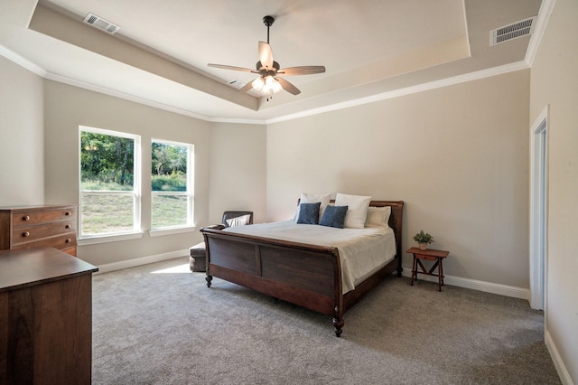 bedroom with a raised ceiling, baseboards, and visible vents