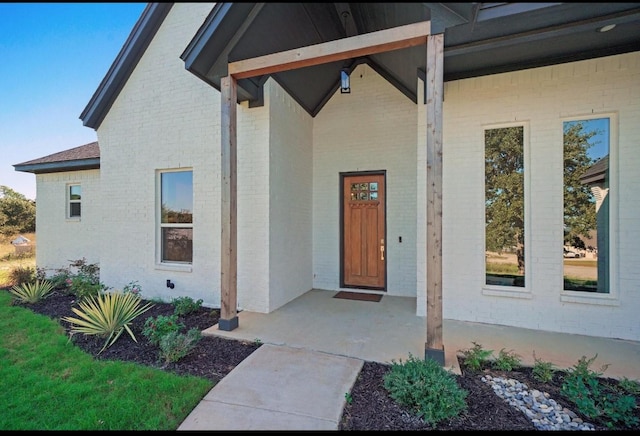 entrance to property with brick siding