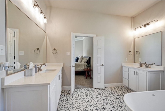 full bathroom featuring ensuite bath, two vanities, a sink, and tile patterned floors