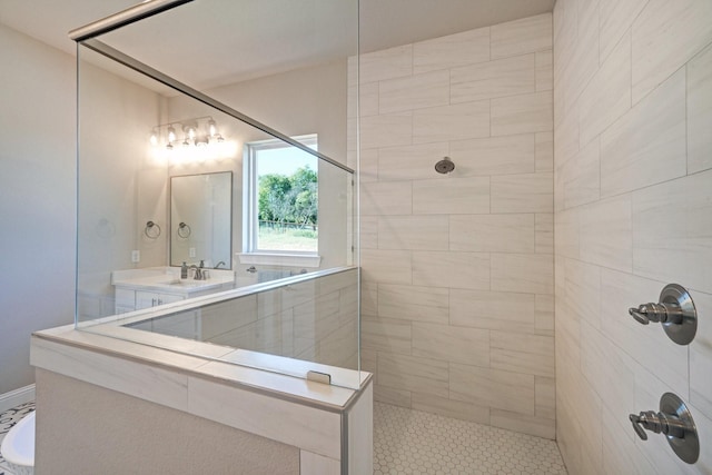 bathroom featuring a walk in shower and vanity