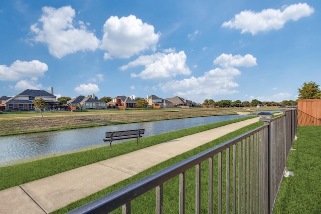 water view featuring a residential view and fence