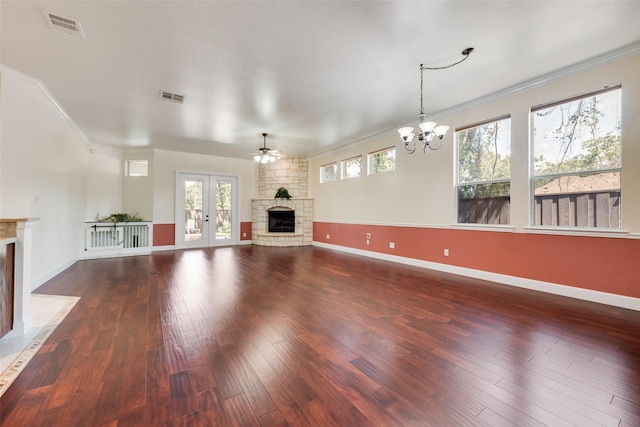 unfurnished living room featuring visible vents, crown molding, a stone fireplace, and wood finished floors