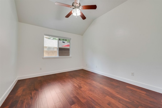 empty room featuring lofted ceiling, ceiling fan, baseboards, and dark wood-style flooring