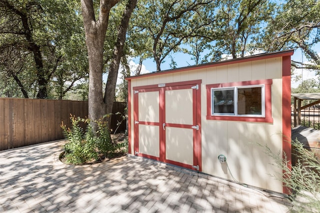 view of shed featuring fence