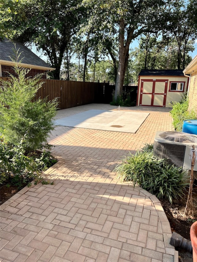 view of patio / terrace with fence, cooling unit, and an outdoor structure