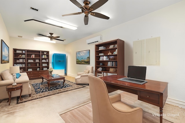 office space featuring a wall mounted air conditioner, baseboards, a ceiling fan, and wood finished floors