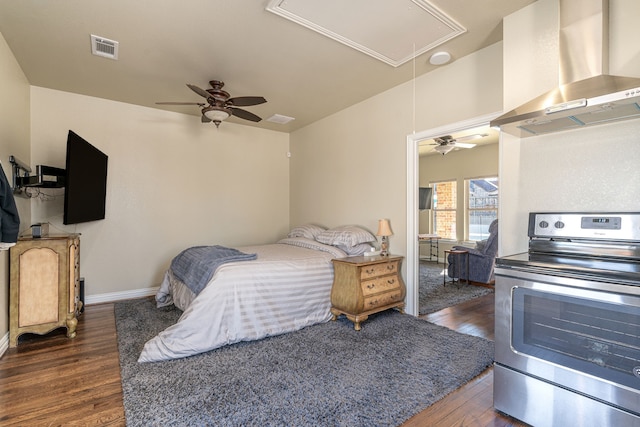 bedroom featuring visible vents, baseboards, attic access, and dark wood finished floors