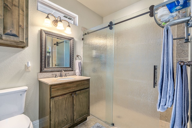 bathroom with toilet, vanity, and a stall shower