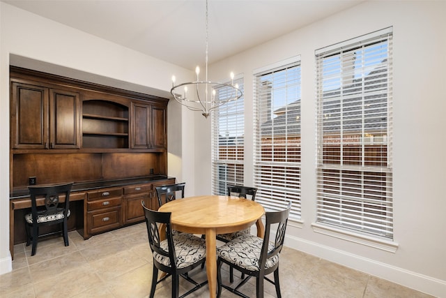 dining space featuring baseboards, an inviting chandelier, light tile patterned flooring, and built in study area