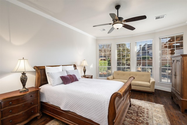 bedroom with visible vents, crown molding, a ceiling fan, and wood finished floors