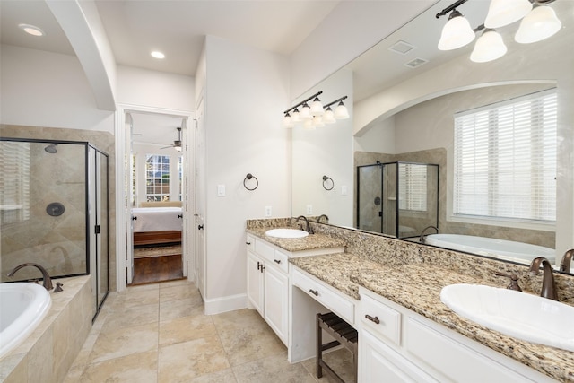 full bathroom featuring a shower stall, a bath, double vanity, and a sink