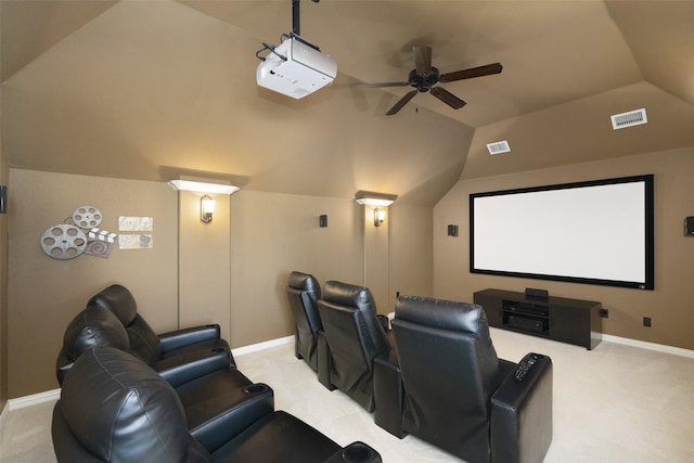 cinema room with visible vents, light colored carpet, baseboards, and vaulted ceiling