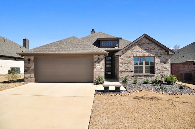 view of front of property with driveway, brick siding, roof with shingles, and an attached garage