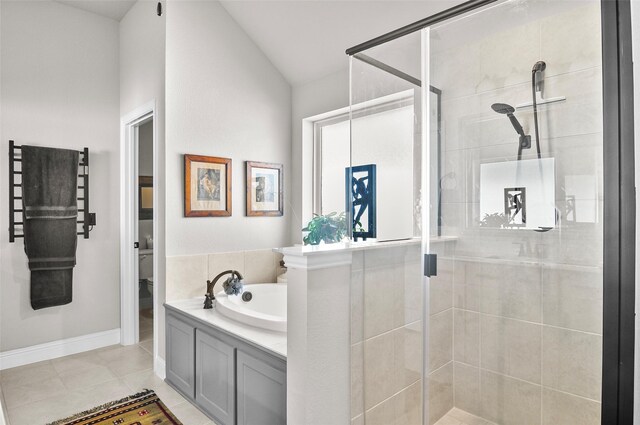 full bathroom featuring toilet, tile patterned flooring, vaulted ceiling, a shower stall, and a bath