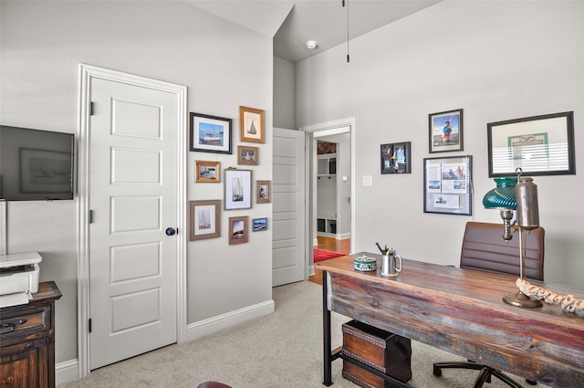 home office with light carpet and baseboards