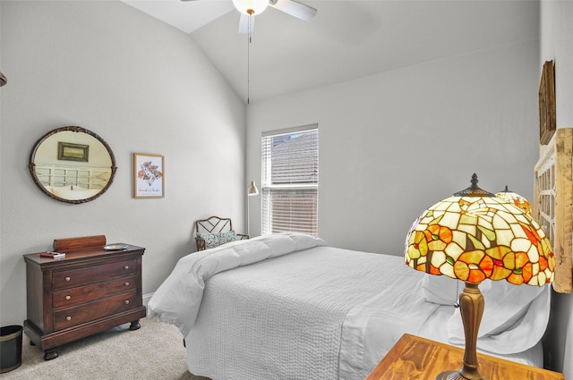 bedroom with vaulted ceiling, ceiling fan, and carpet flooring