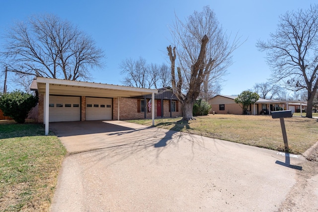 mid-century home featuring a garage, concrete driveway, brick siding, and a front lawn