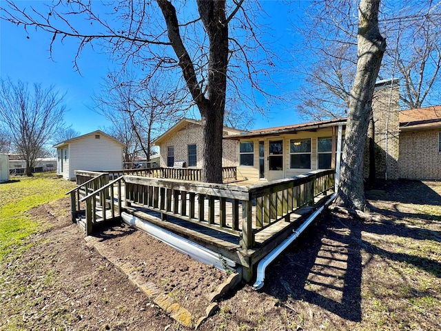 rear view of property featuring a deck