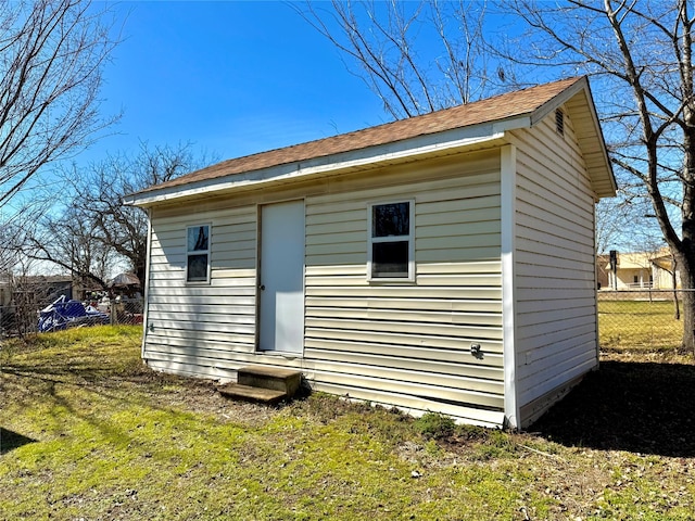 view of outbuilding with an outdoor structure and fence