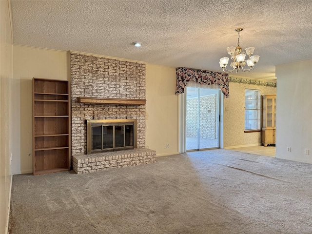 unfurnished living room featuring carpet, a notable chandelier, a fireplace, and a textured ceiling