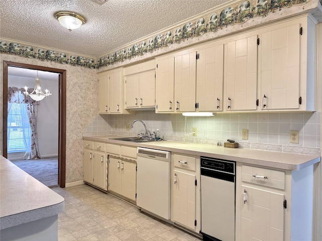 kitchen featuring wallpapered walls, dishwasher, light countertops, a textured ceiling, and a sink