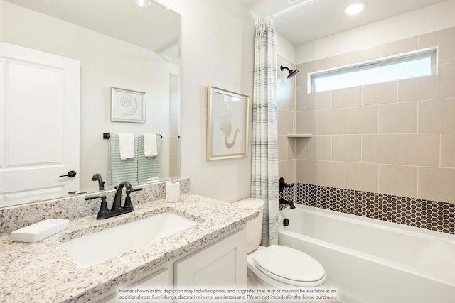 bathroom featuring shower / tub combo with curtain, vanity, and toilet