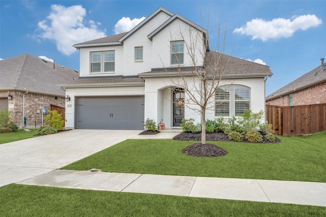 traditional-style house with driveway, an attached garage, a front lawn, brick siding, and fence