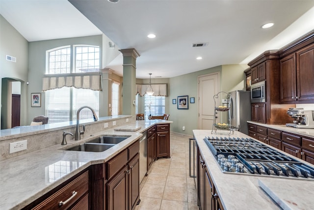 kitchen featuring stainless steel appliances, visible vents, a sink, and light tile patterned floors