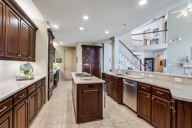 kitchen with light tile patterned floors, stainless steel appliances, tasteful backsplash, and a kitchen island