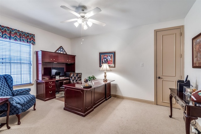 office with ceiling fan, baseboards, and light colored carpet