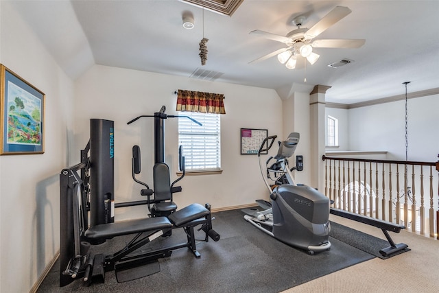 workout room with attic access, visible vents, vaulted ceiling, and a ceiling fan