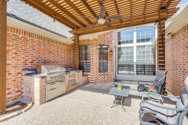 view of patio with exterior kitchen, ceiling fan, area for grilling, and a pergola