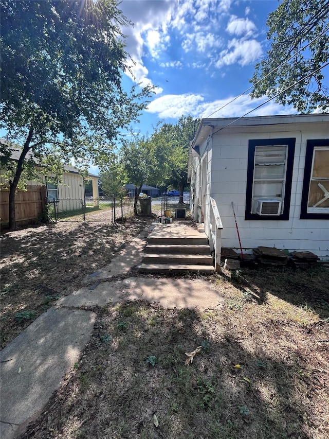 view of home's exterior featuring fence and an outdoor structure