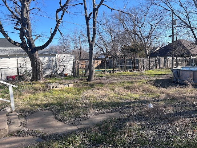 view of yard featuring a fenced in pool and fence