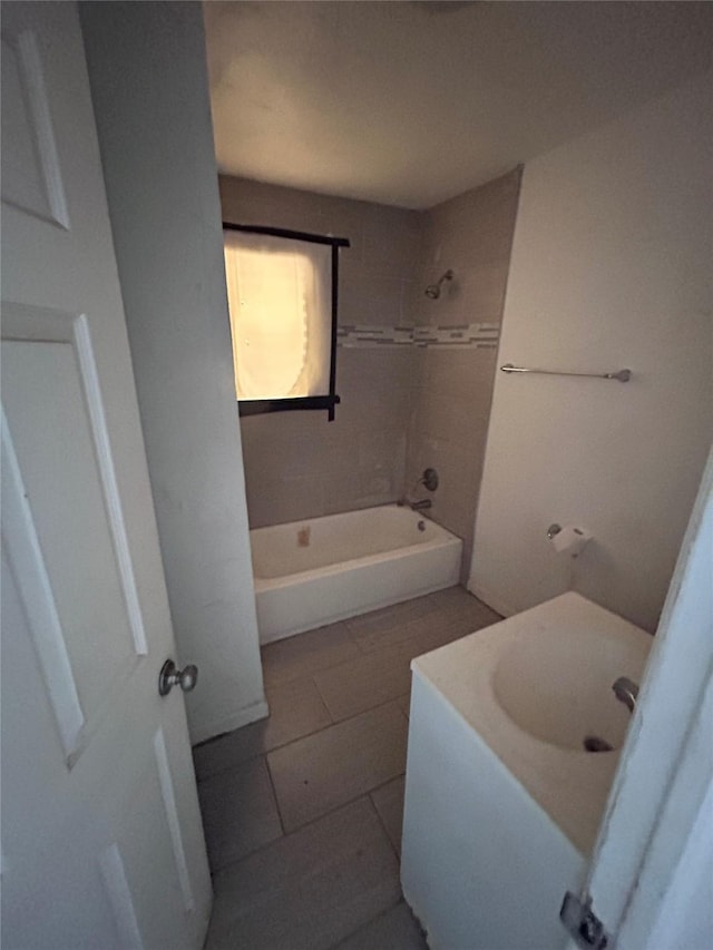 full bathroom with bathtub / shower combination, a sink, and tile patterned floors