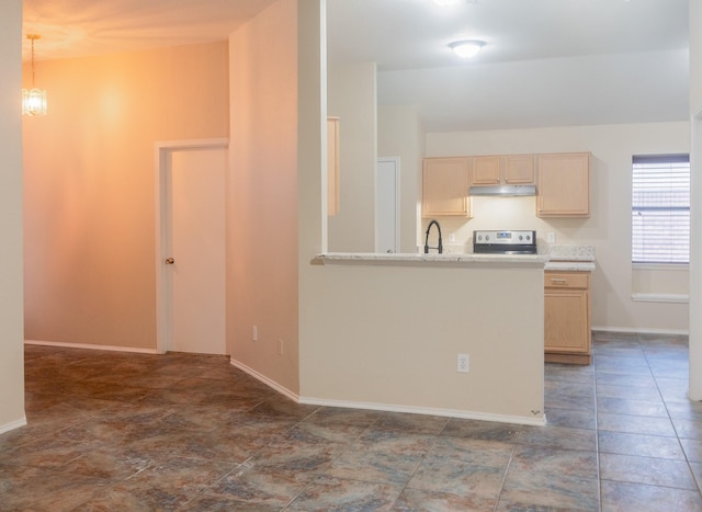 kitchen with under cabinet range hood, light countertops, light brown cabinetry, stainless steel range with electric stovetop, and a sink