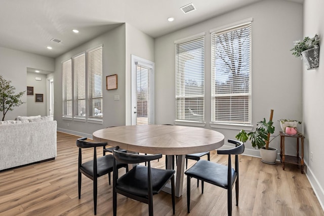 dining area with light wood finished floors, baseboards, visible vents, and recessed lighting