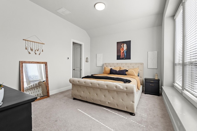 bedroom with carpet floors, lofted ceiling, visible vents, and baseboards