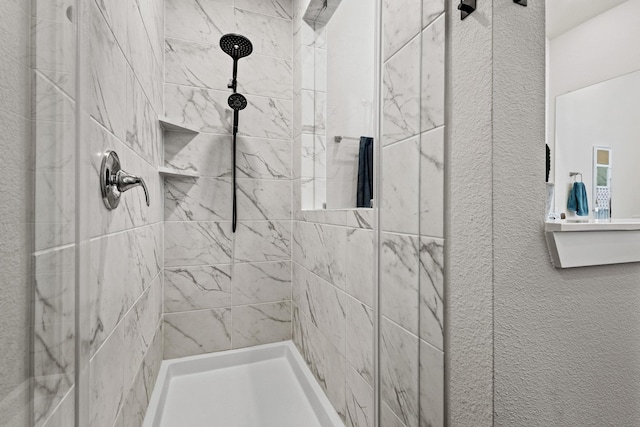 bathroom featuring tiled shower