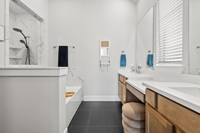 full bath featuring a marble finish shower, tile patterned floors, vanity, baseboards, and a bath