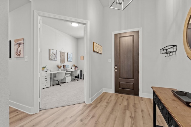 entrance foyer featuring light wood-type flooring and baseboards