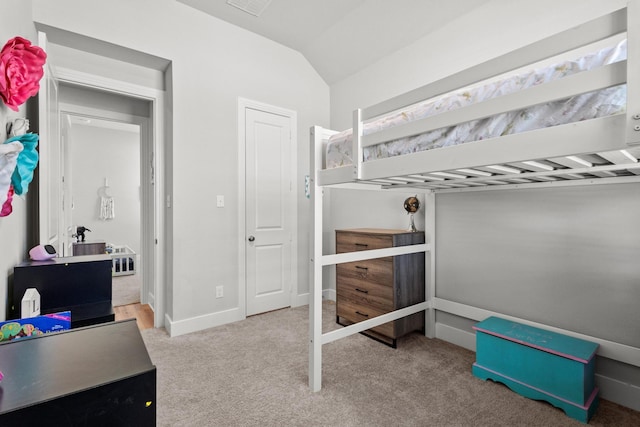 carpeted bedroom featuring lofted ceiling and baseboards