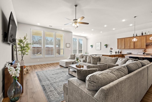 living room with ceiling fan, recessed lighting, visible vents, baseboards, and light wood-style floors