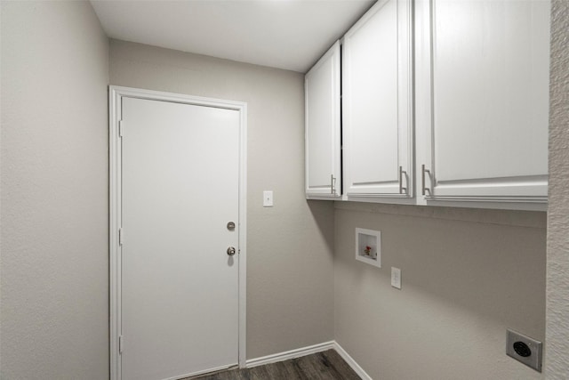 washroom with hookup for a washing machine, cabinet space, dark wood-type flooring, hookup for an electric dryer, and baseboards