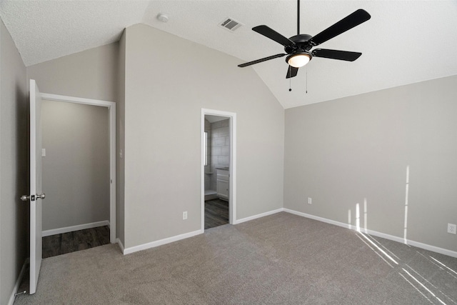 unfurnished bedroom with lofted ceiling, carpet floors, and visible vents