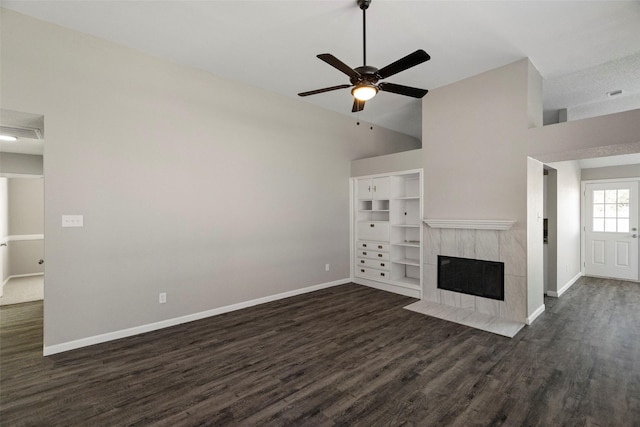 unfurnished living room with a ceiling fan, a tile fireplace, dark wood finished floors, and baseboards