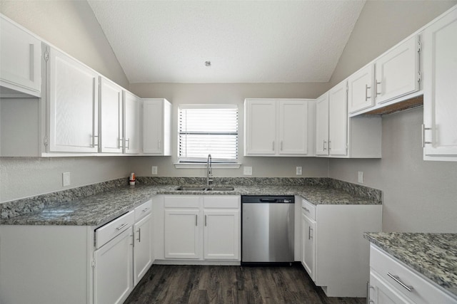 kitchen featuring dishwasher, a sink, white cabinetry, and lofted ceiling